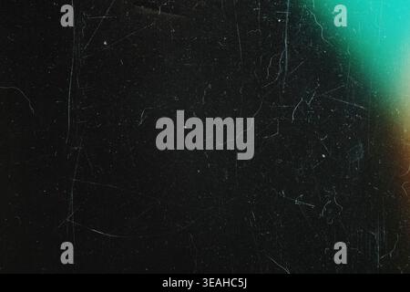 Black analog film texture with subtle green light leak and vintage dust marks Stock Photo