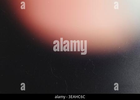 Warm peach light leak gradient on dark grunge background with subtle dust Stock Photo