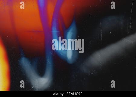 Wavy blue and purple light leak trails with orange vintage film texture Stock Photo