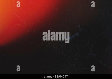 Minimalist dark analog texture with top left red light flare and subtle scratches Stock Photo