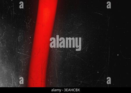 Vibrant red vertical light beam with vintage film scratch overlay Stock Photo
