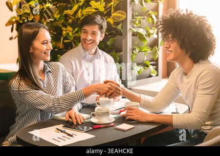 Business Meeting in a Cafe With Diverse Individuals Discussing Projects and Ideas Stock Photo