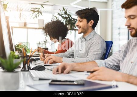 Professionals Collaborating in a Modern Office Environment During the Afternoon Stock Photo