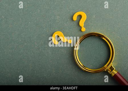 Magnifying glass beside a question mark. Concept of counseling for problems, solutions, and confusion. Stock Photo