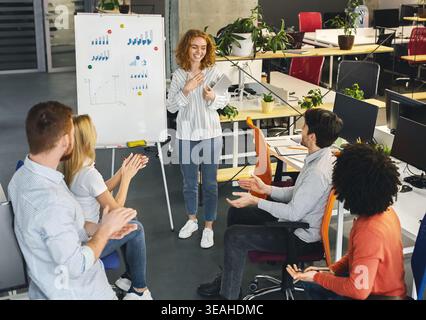 Woman team leader making presentation for colleagues Stock Photo