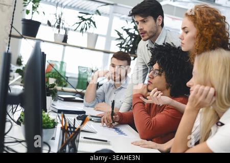 Group of Diverse Colleagues Collaborating on a Project in a Bright Office Environment Stock Photo