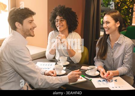 Cheerful business partners discussing strategy of new start up project Stock Photo