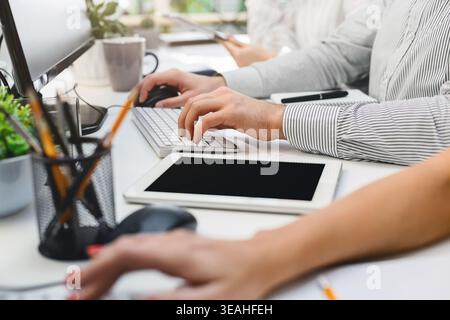 Team Collaborating in a Modern Office While Using Technology for Productivity and Communication Stock Photo