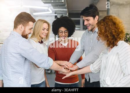 Collaboration and Teamwork Among Diverse Individuals in a Modern Workspace Stock Photo