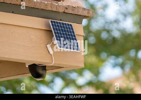 Solar powered security camera mounted on house exterior Stock Photo