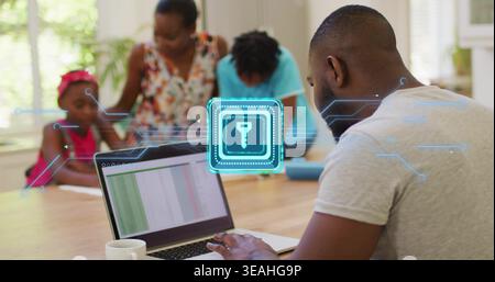 Typing man in gray tee using laptop at home with mug and security icon, copy space Stock Photo