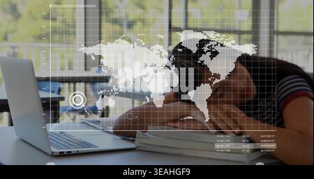 Resting student wearing striped top, leaning head on books at desk, laptop, digital map overlay Stock Photo