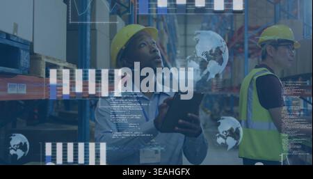 Holding tablet worker wearing yellow hard hat scanning racks in warehouse aisle with data overlays Stock Photo