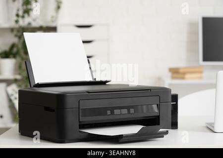 Modern printer on desk in office Stock Photo