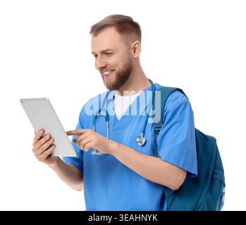 Handsome medical intern using tablet computer on white background Stock Photo