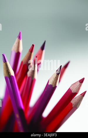 A close-up of a set of sharpened colored pencils in various colors, arranged in a fan-like formation. Stock Photo