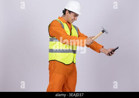 Construction worker in safety vest holding a hammer Stock Photo