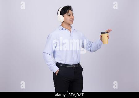 Young businessman holding a cup of coffee and gesturing Stock Photo