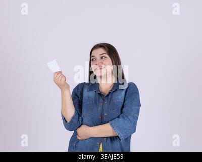 Woman holding a credit card and smiling at camera Stock Photo