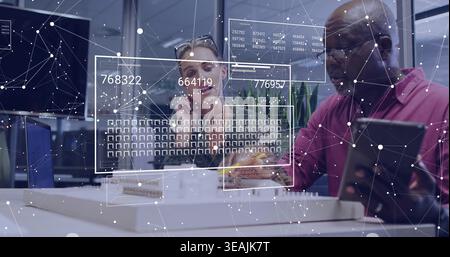 Leaning designers in blazer and magenta shirt examining scale model at office with tablet overlays Stock Photo