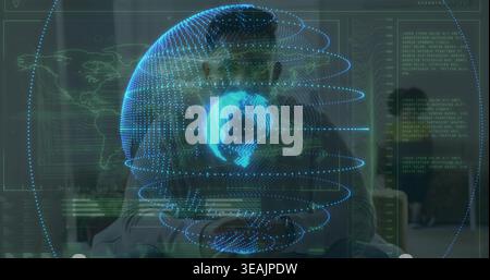 Projecting holographic globe and data display over couple in casual clothes in living room Stock Photo