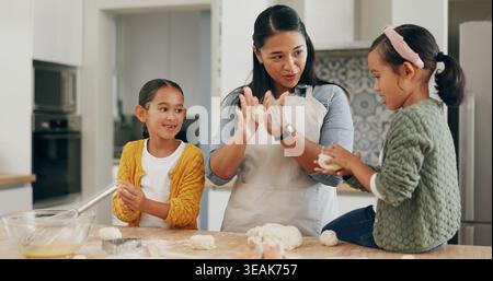 Home, mom and children baking with dough for teaching dessert recipe, bonding or development. Kneading, mother or kids with pastry preparation for Stock Photo