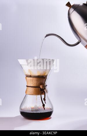 Elegant Manual Coffee Preparation Process. Meticulous Chemex Pour Over With Attentive Craftsmanship Stock Photo