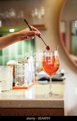 Evening Lounge Ambiance Highlighted By Skilled Mixologist Preparing Vibrant Orange Beverage Stock Photo