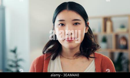 Happy, calm and portrait of Asian woman in home with positive attitude, good mood and confidence. Homeowner, apartment and person in living room for Stock Photo