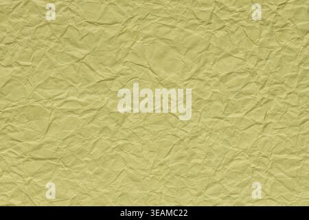 Crumpled yellow paper texture background with wrinkles and folds for creative design Stock Photo
