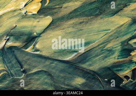 Abstract green and gold oil paint texture with glitter brush strokes and metallic shimmer Stock Photo