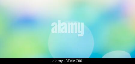 Green blue and teal abstract bokeh background with large glowing light circle Stock Photo