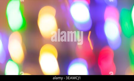 Abstract defocused colorful bokeh lights with multicolor circles for a festive holiday background Stock Photo