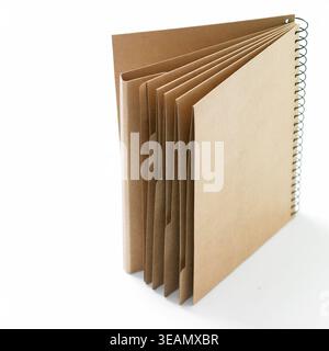 A spiral-bound notebook made of brown paper, opened to show its blank pages. Stock Photo
