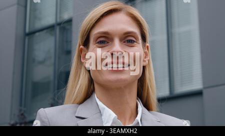 Headshot successful Caucasian adult business woman thinking smiling at camera looking happy dreaming businesswoman female leader professional manager Stock Photo