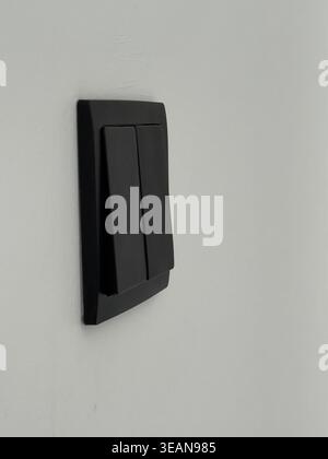 Light switch on white wall with minimalist design and modern style, suitable as background. Mobile photo Stock Photo