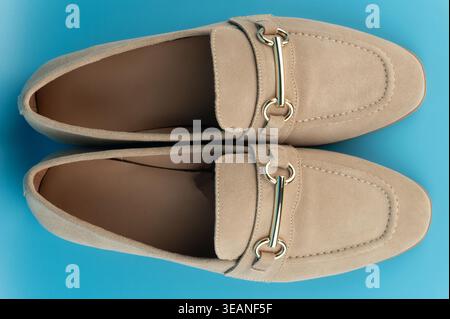 Classic comfortable brown leather shoes  above top view on blue studio background Stock Photo