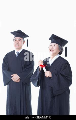middle aged man in graduation formal dress, mortar board and gown in ...