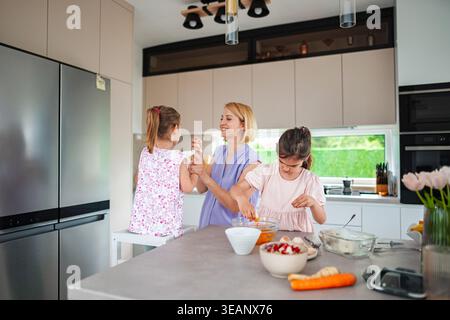 Baking together in a modern kitchen with family joy Stock Photo