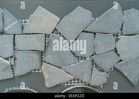 Close-up of irregular stone mosaic tiles. Natural texture with organic shapes.  Stock Photo