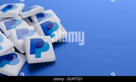 Logo of the online payment system PayPal in a big pile on a blue background with copy space as web banner header Stock Photo