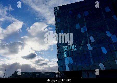 Modern Glass Architecture Facade With Hexagonal Panels Reflecting Blue Sky and Clouds, Urban Design Stock Photo