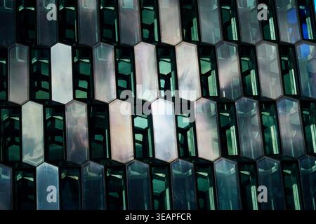Geometric Glass Facade With Hexagonal Windows Reflecting Light On Modern Architectural Building Exterior Stock Photo