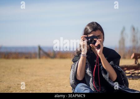 Hispanic American woman photographing the viewer Stock Photo
