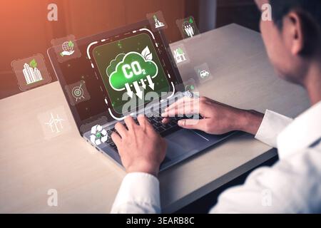 Young Professional Using Laptop with Cloud Technology and CO2 Reduction Concept in a Modern Office for Sustainable Development Goals Sigmoid Stock Photo