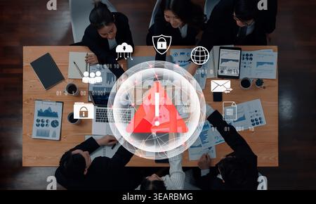 Red warning triangle representing a cybersecurity threat or data breach alert, surrounded by digital security and network protection icons Stock Photo