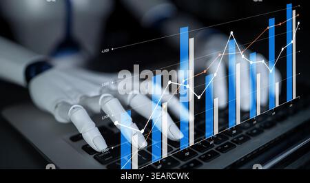 Robotic hands interact with a laptop screen displaying graphs and charts, symbolizing the intersection of technology and finance in modern data Stock Photo