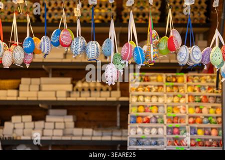 Colorful decorated Easter eggs hanging for sale at a traditional market stall in Prague Stock Photo