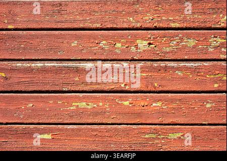 Old shabby wooden boards texture with cracked red paint in grunge style Stock Photo