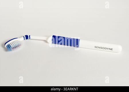Used Sensodyne toothbrush on white Stock Photo